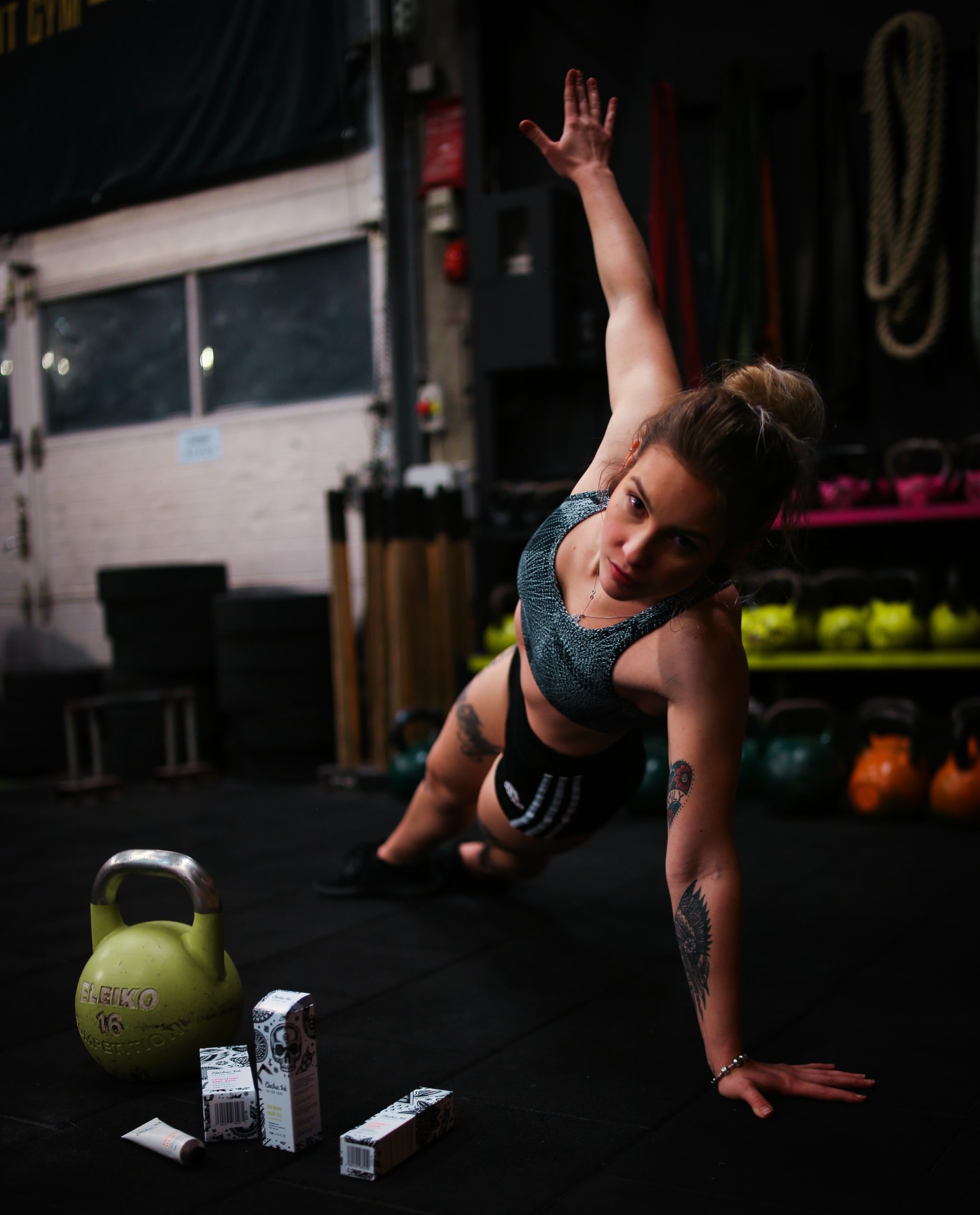 photo of strong woman at gym exercising representing sports acupuncture for care